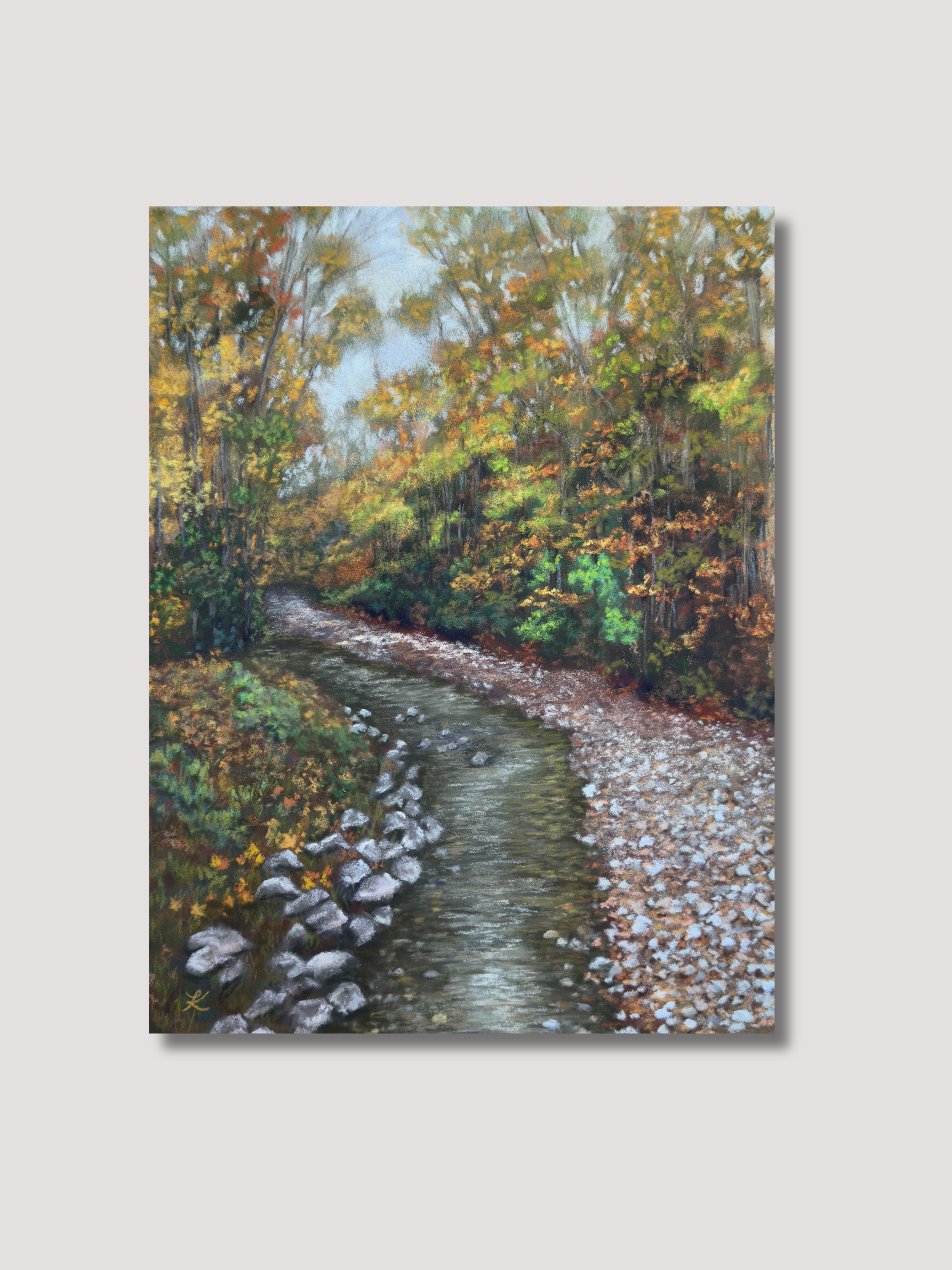 Painting of Vermont fall stream surrounded by trees filled with leaves of green, gold, and orange