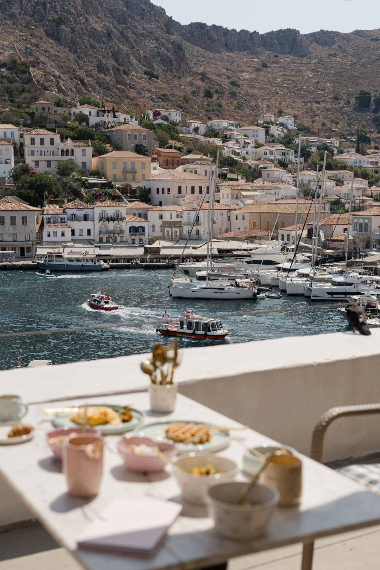 Two women in workout attire sitting on Pilates reformer, smiling.
