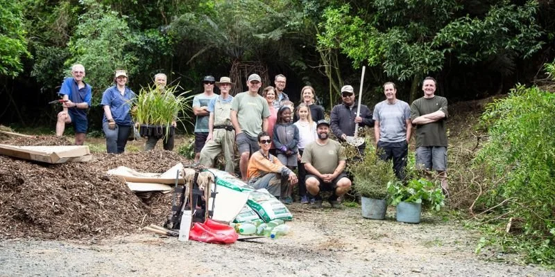 group of people for working bee smiling in native bush