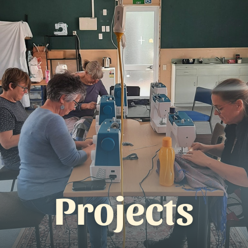 women at tables with sewing machines