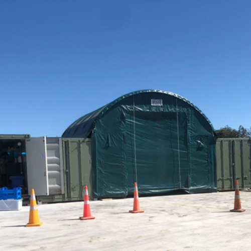 Shipping Containers with tent canopy between