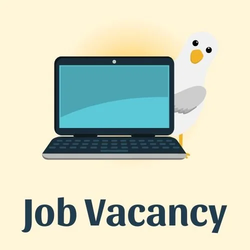 cartoon seagull standing behind laptop