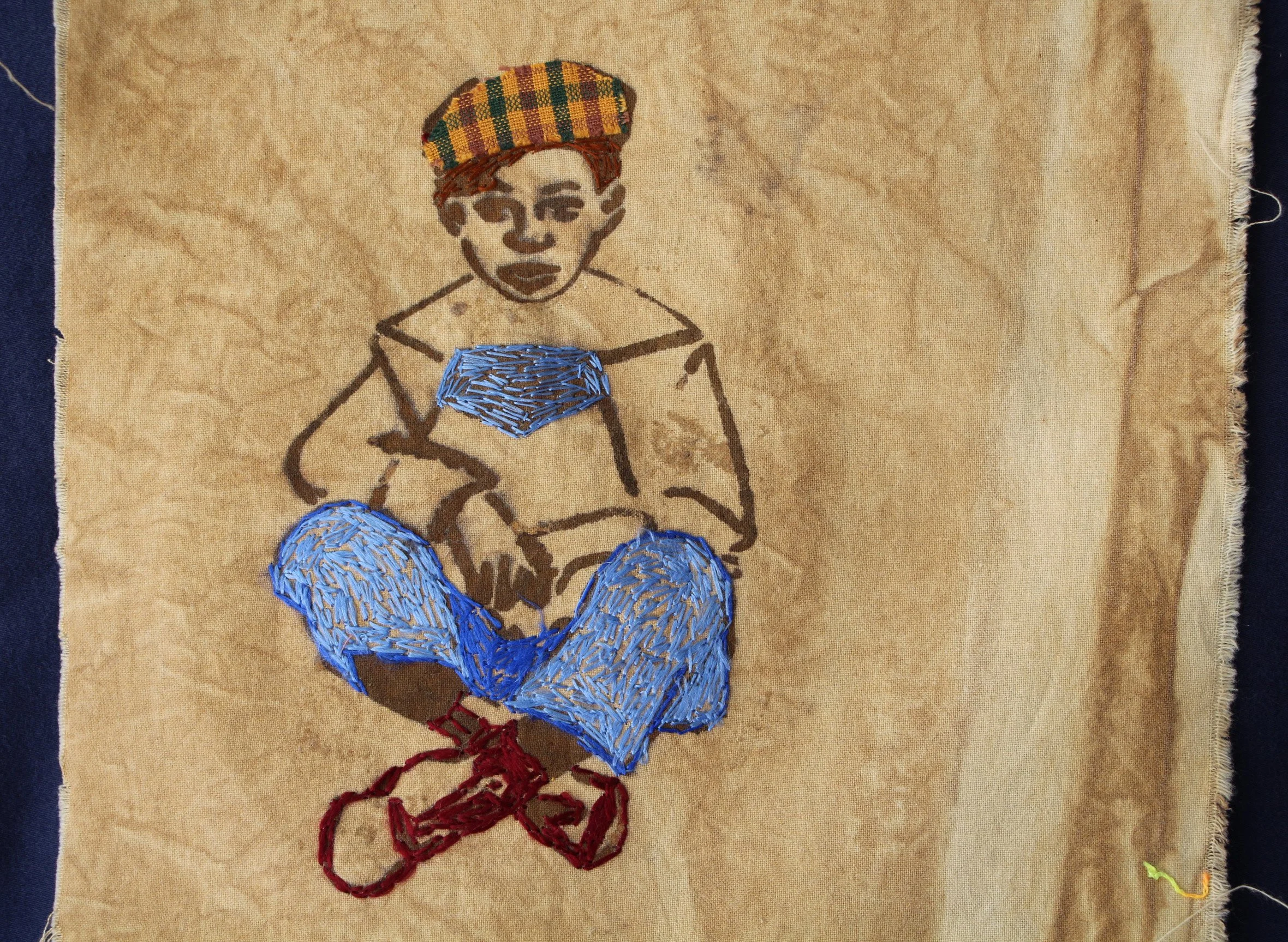 Boy with Harris Tweed Hat (2026)— Small cotton swatch, dyed with oak gall tannin, iron mordant print, silk embroidery