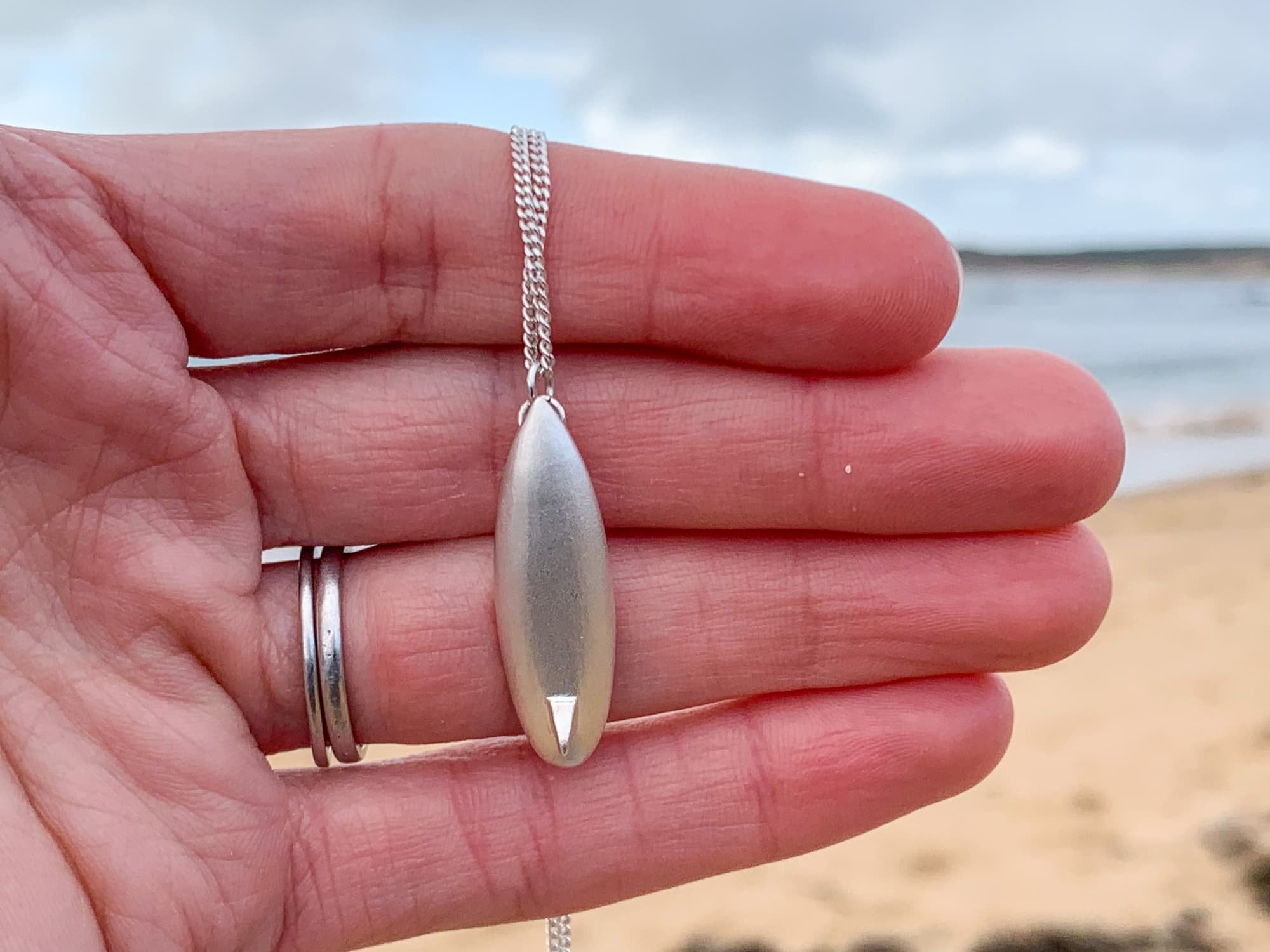 Surfboard. Necklace.