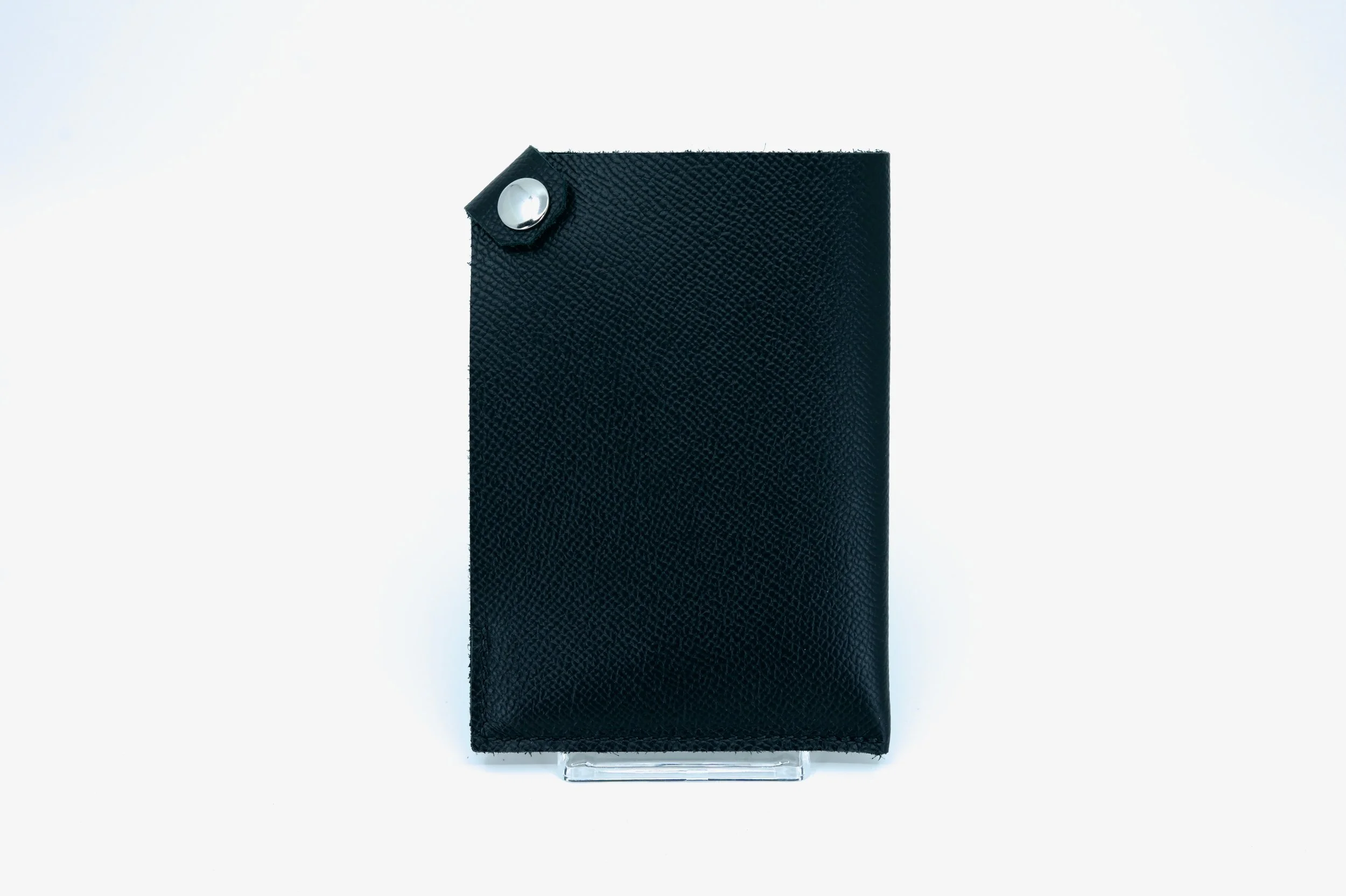 Saddle-stitched leather passport holder for Cuirated referral program