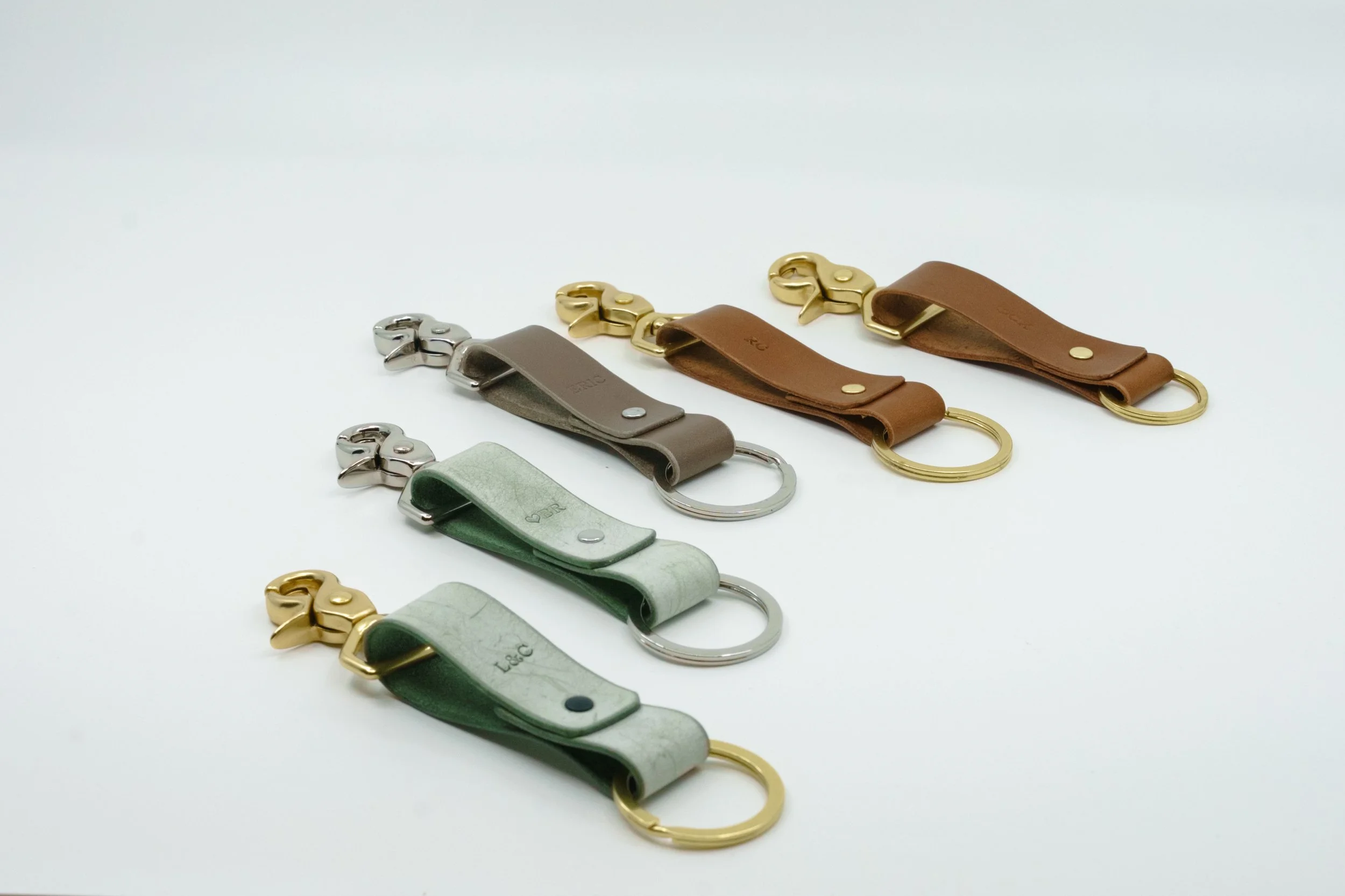 Five Italian leather keychains with solid brass hardware crafted during team onsite