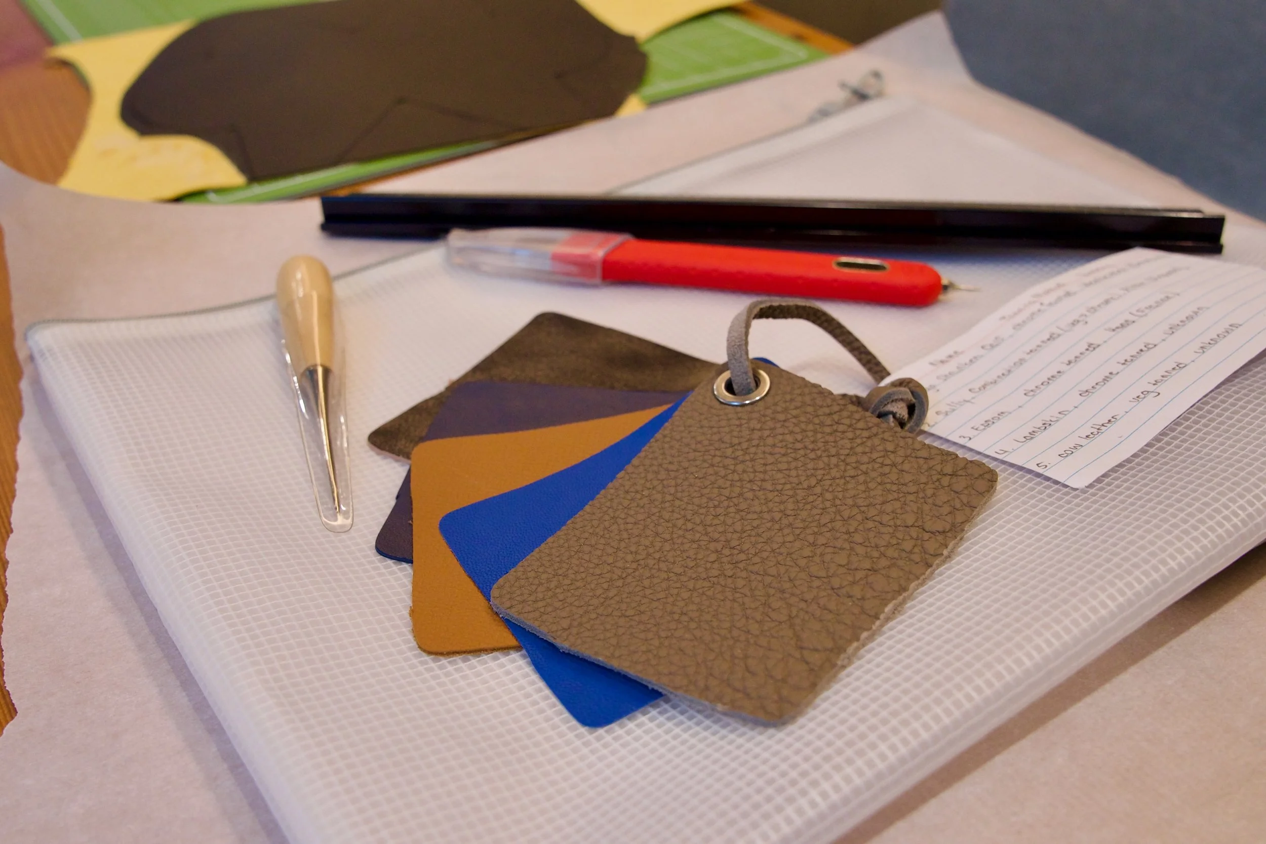 Custom leather craft kit, tools, and hardware packaged for individual shipment to remote employees.