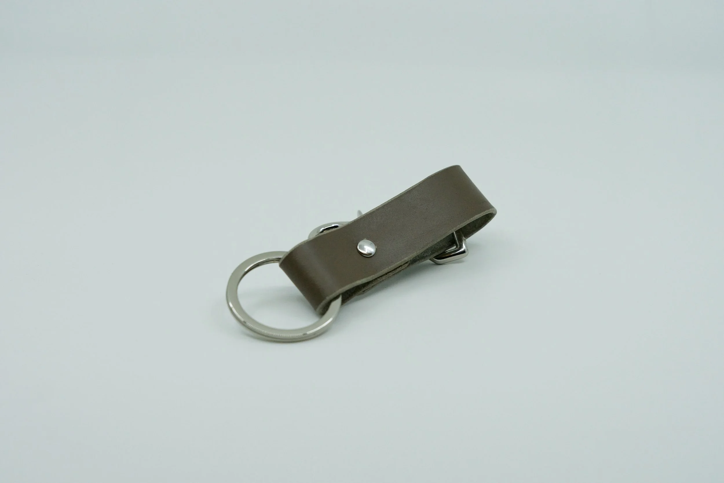 Completed handmade leather keychain created during a remote team-building session.