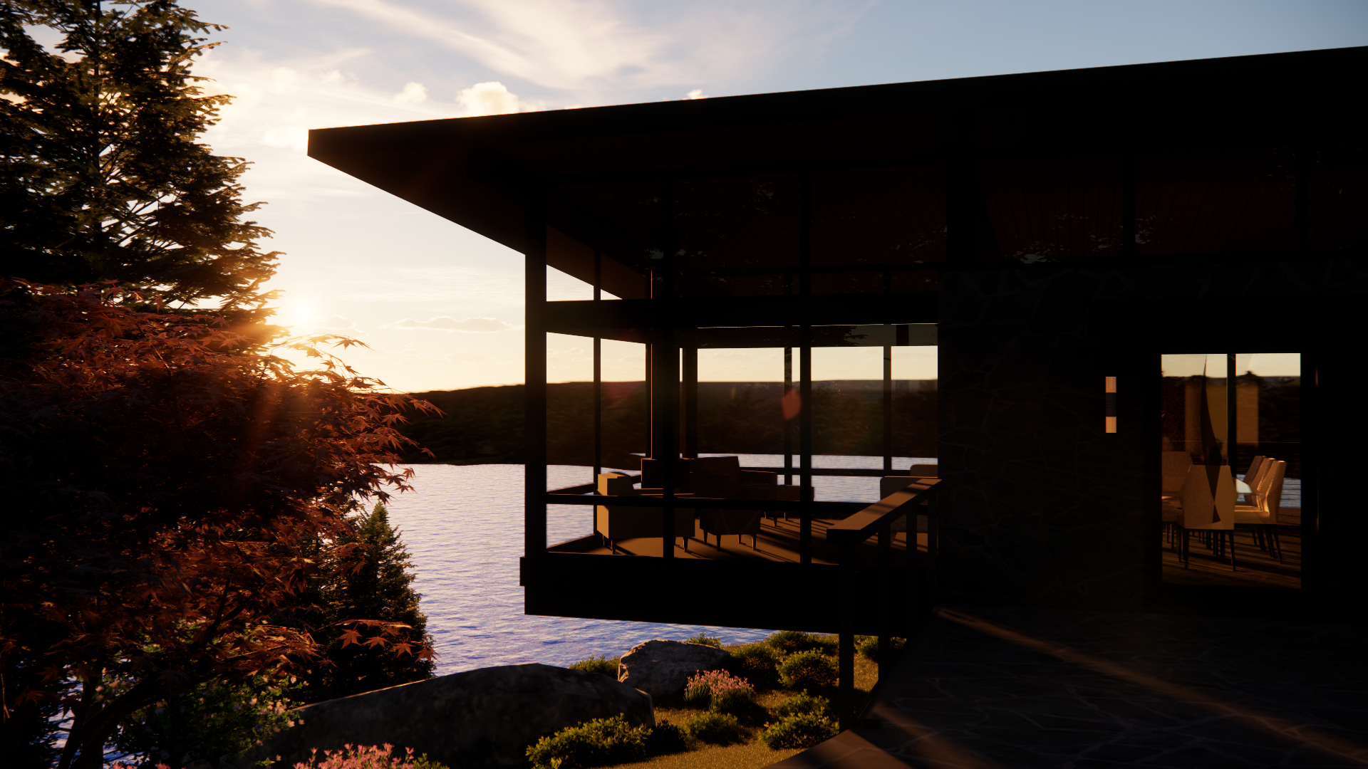 Sunset over a lake viewed through the large glass windows of a modern house with a balcony, surrounded by trees and rocks.