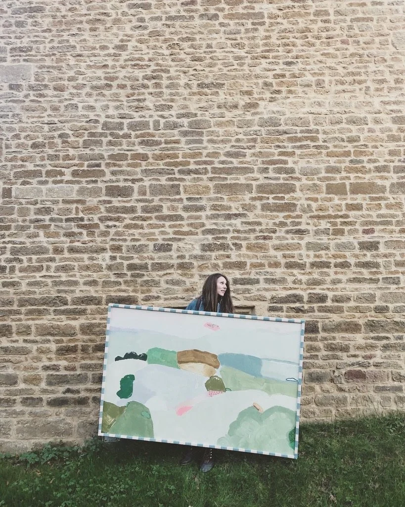 Artist Philippa Jeffrey with a large scale original painting in a bespoke fabric frame