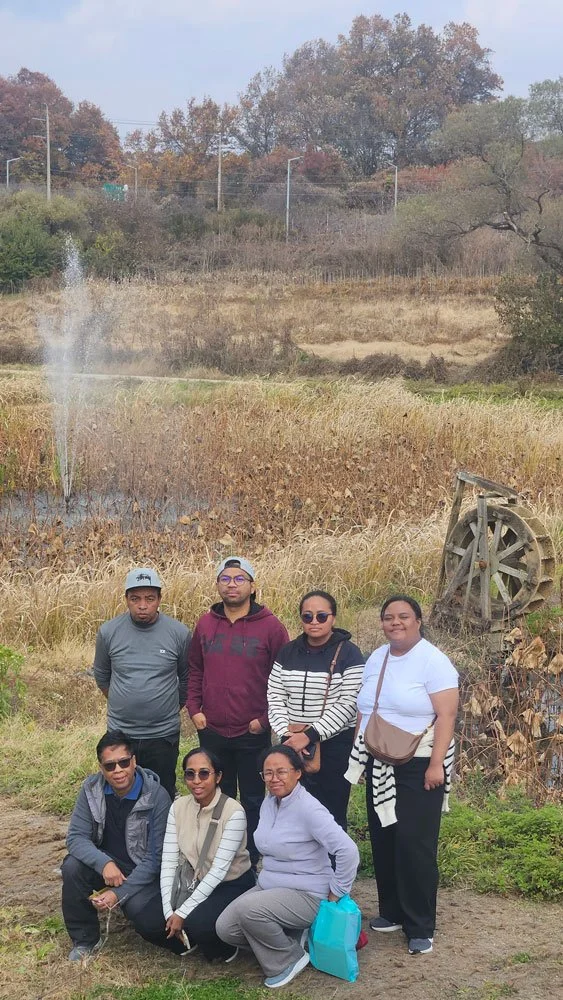 Madagascar tourists experiencing Tongilchon village, peaceful landscape with traditional houses and greenery, immersive cultural travel experience, vibrant colors, professional photography style