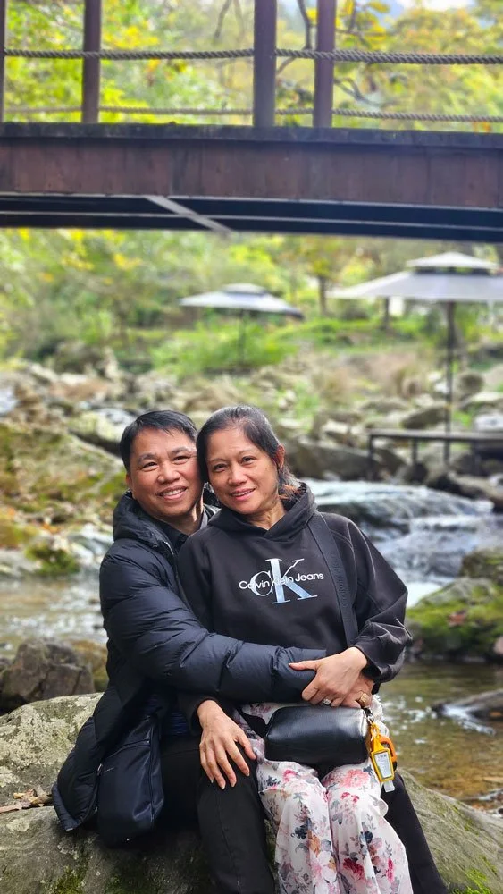 Filipino tourists on a private tour walking through the colorful flower gardens at The Garden of Morning Calm in Korea.