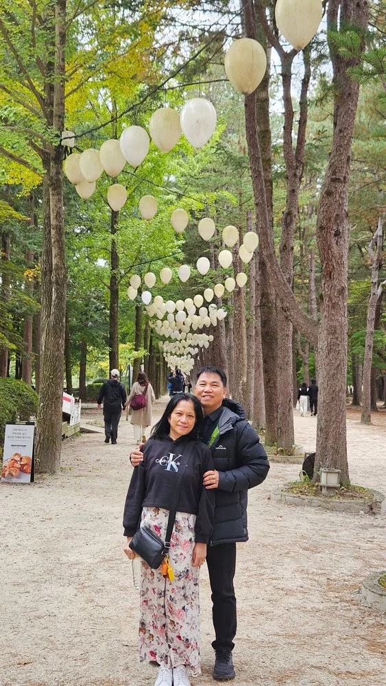 Private tour for Filipino guests riding bicycles along the riverside road on Nami Island.