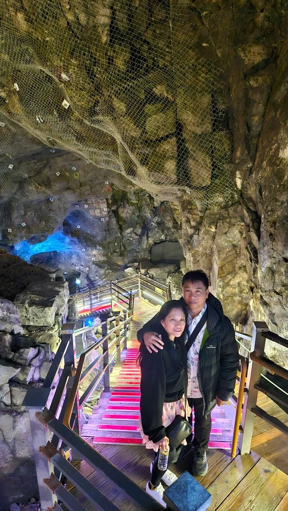 Filipino tourists exploring Gwangmyeong Cave during a private tour, walking through the illuminated underground tunnels.