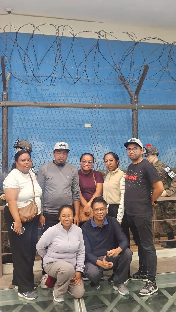 Madagascar tourists walking through the Third Tunnel, dimly lit tunnels, guided tour experience, immersive historical travel photo