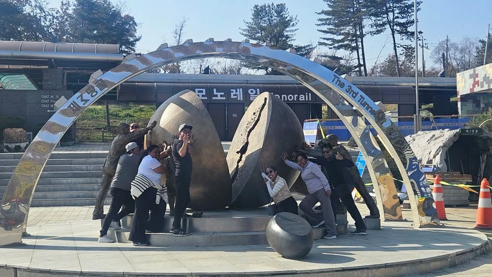 Madagascar travelers on a private tour exploring the Third Tunnel (Dugout) near the DMZ, historical underground passage, dramatic lighting, high-resolution travel photography