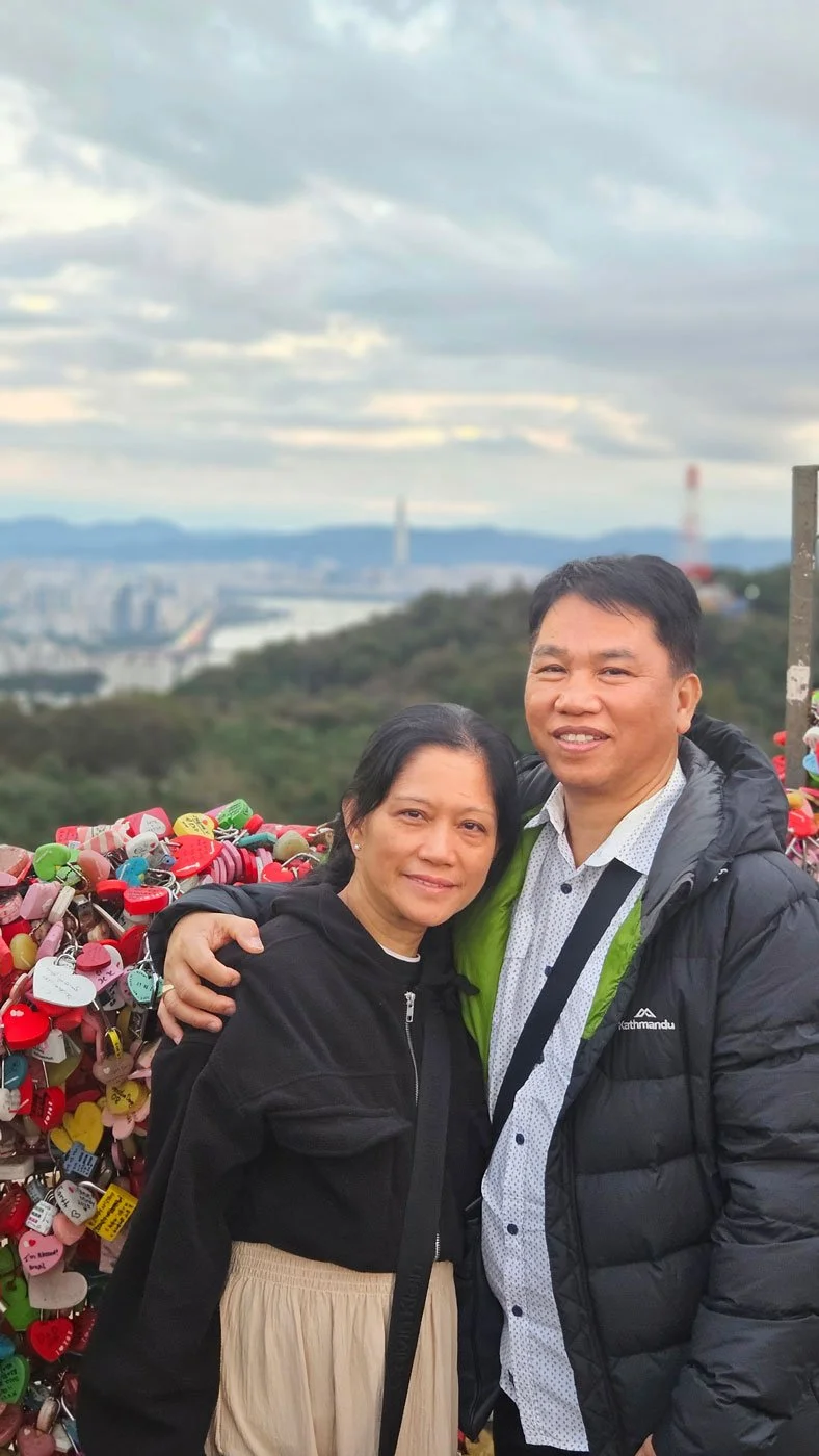 Filipino travelers taking photos at the Love Locks area near N Seoul Tower.