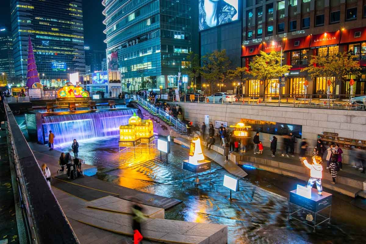Visitors walking along the Cheonggyecheon Stream pathway