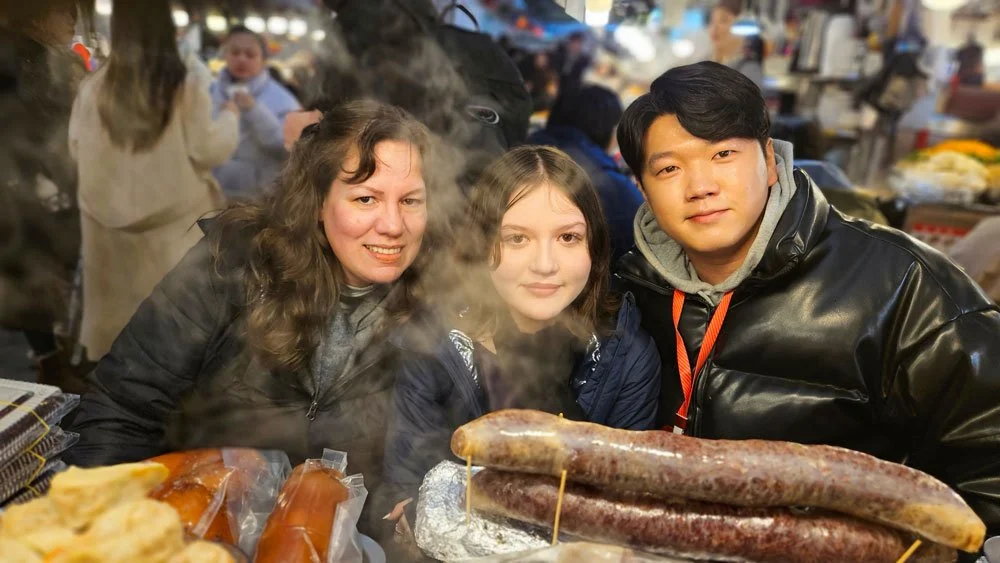 Mexico family enjoying authentic Korean street food at Gwangjang Market.
