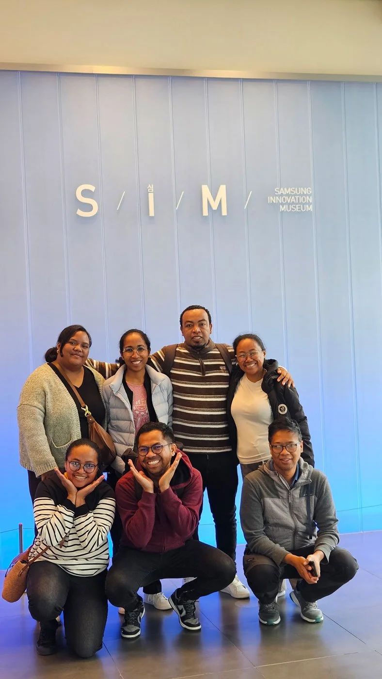 Madagascar travelers exploring Samsung Innovation Center, futuristic technology, modern interior design, educational and cultural experience, professional photography style