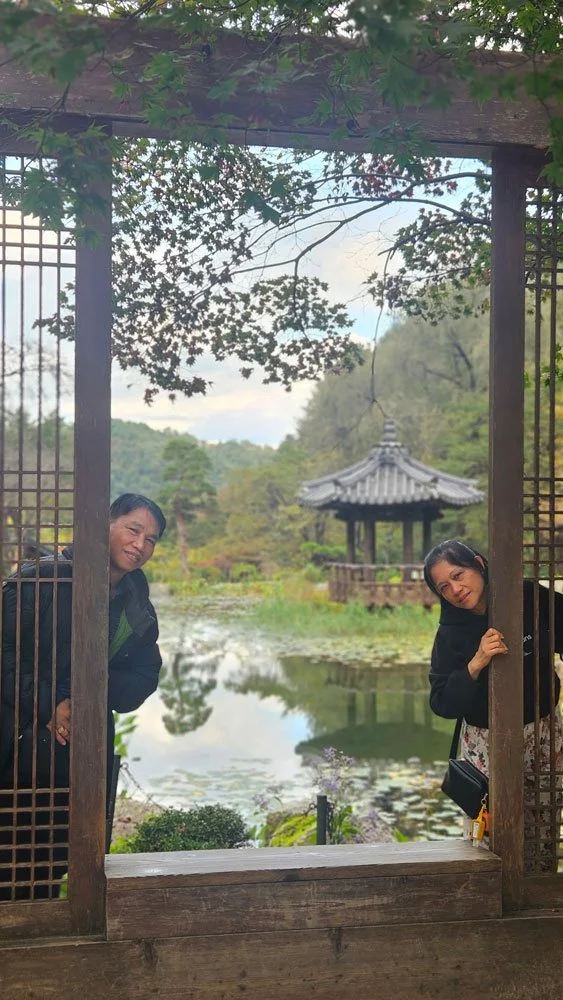 Beautiful landscape view of The Garden of Morning Calm with Filipino tourists taking photos of seasonal flowers.