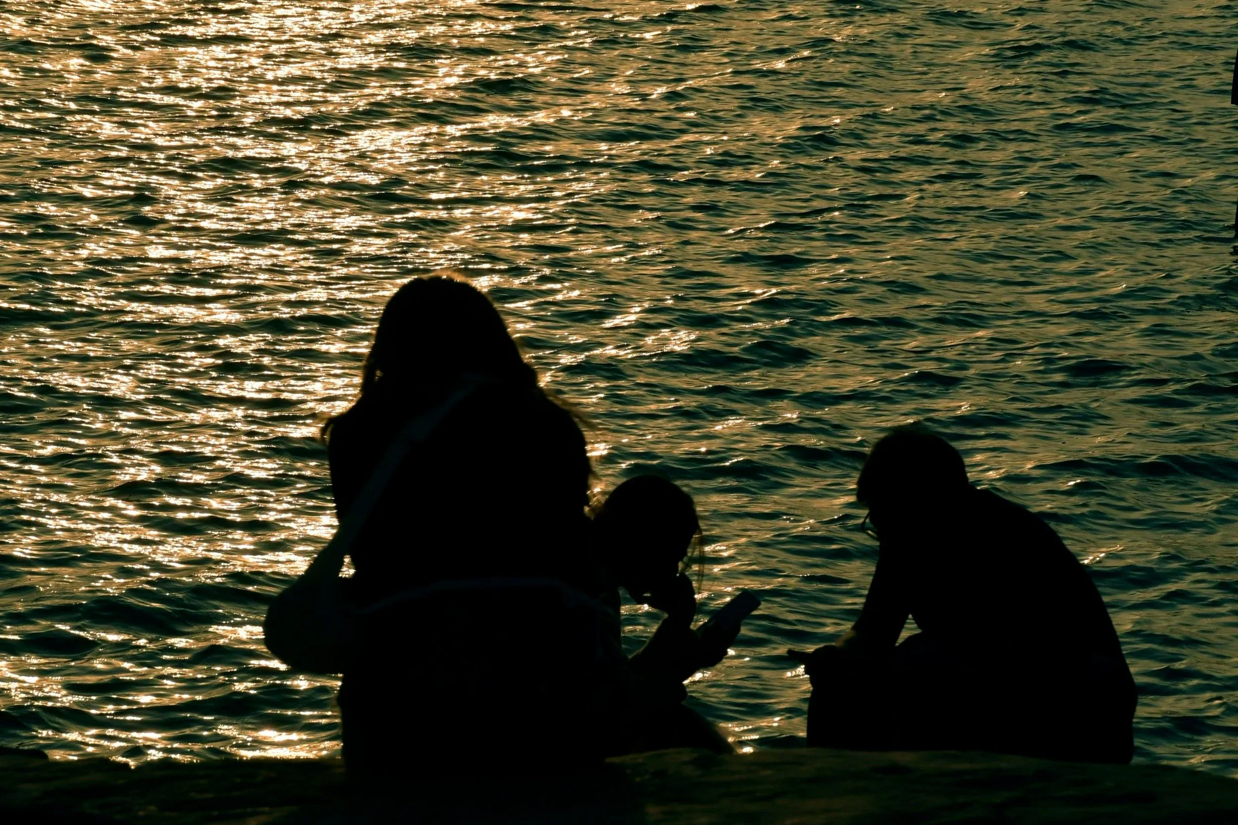 Silhouette of people and a boat