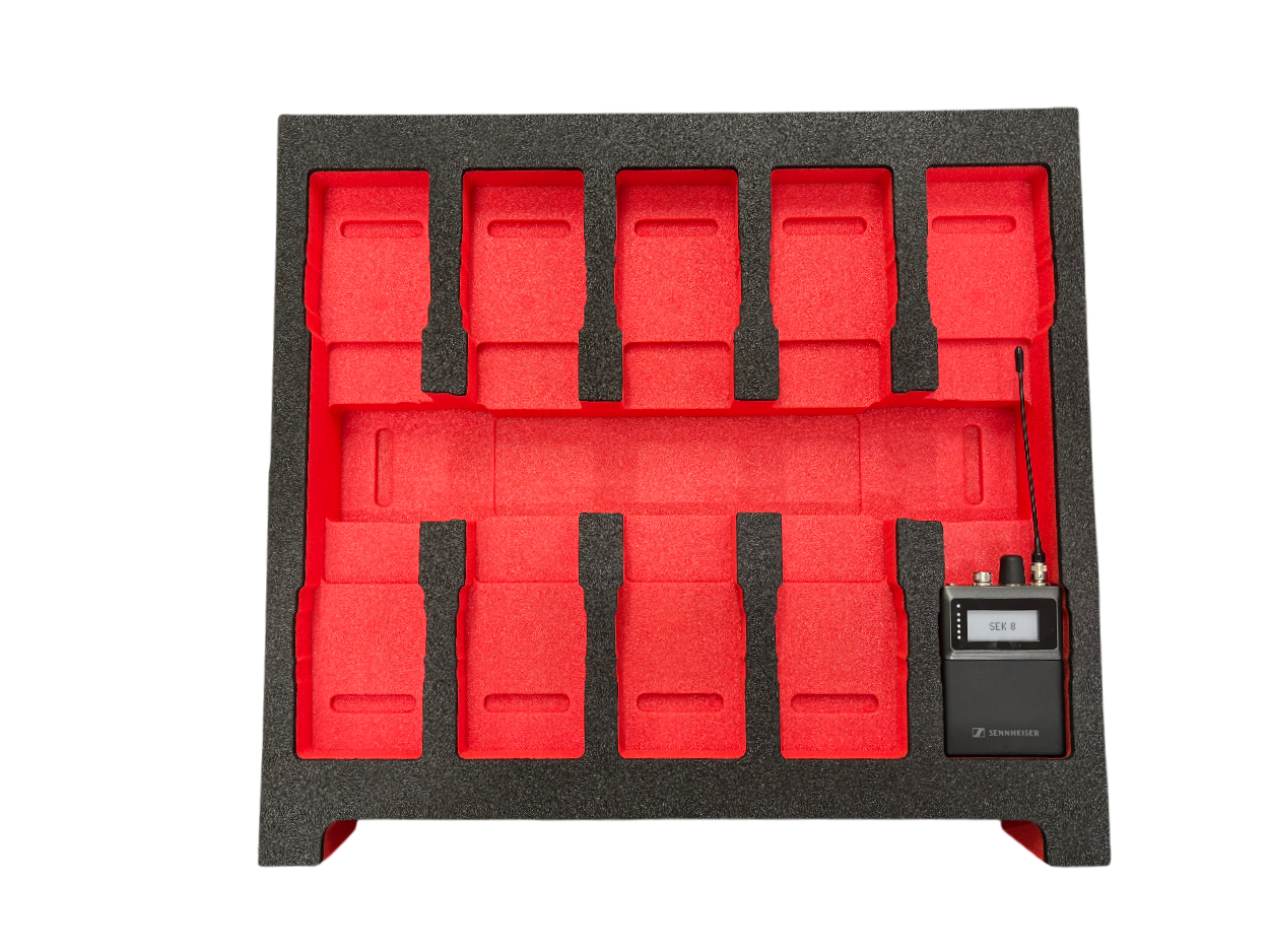A black foam storage tray with red foam inserts and a wireless microphone receiver with an antenna.