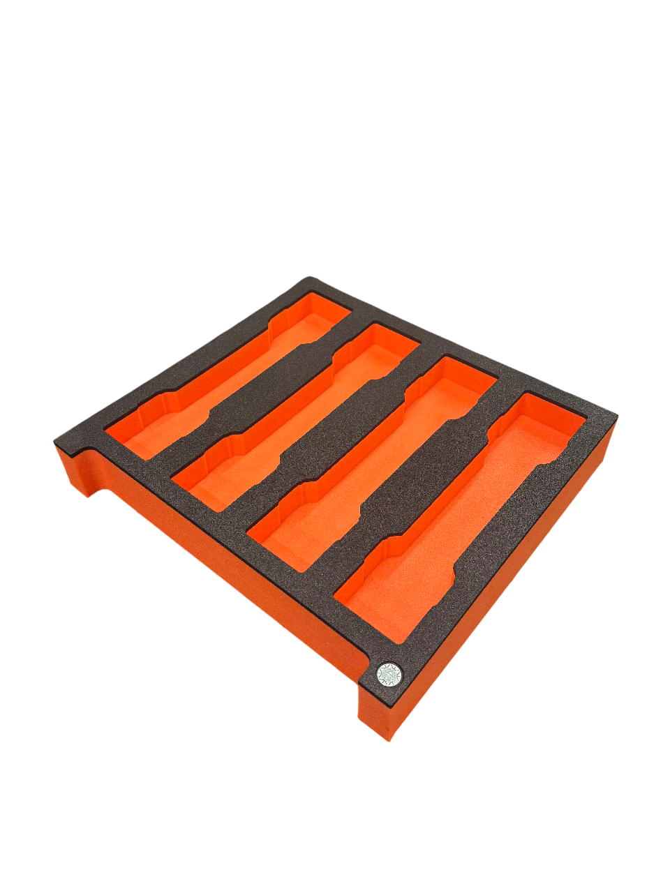 Orange and black foam insert with cutouts for storing tools or equipment.