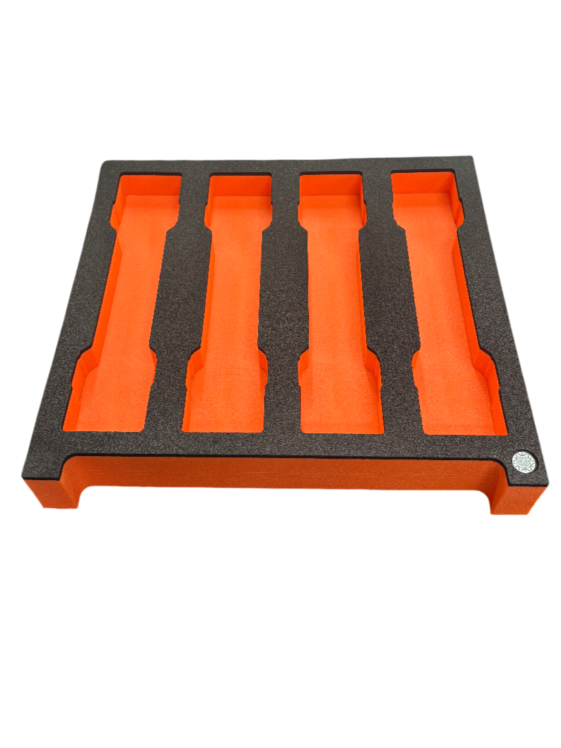 A foam frame with black exterior and orange interior partitions, designed for organizing or storing items.