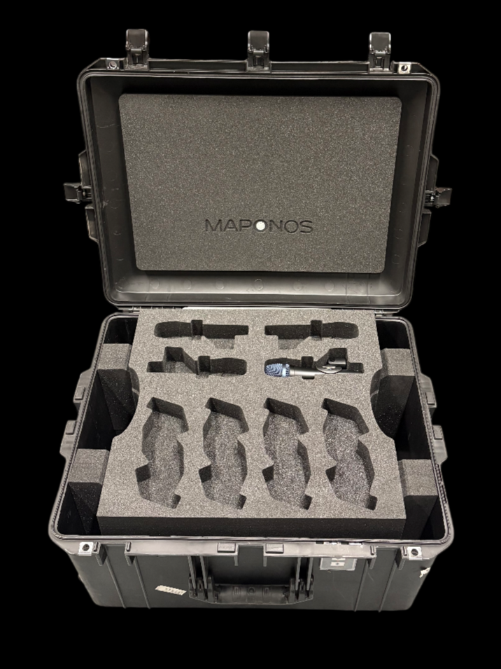 An open black carrying case with custom foam inserts, containing a small component or device and a few small tools or accessories, with the lid displaying the brand name MAPONS.
