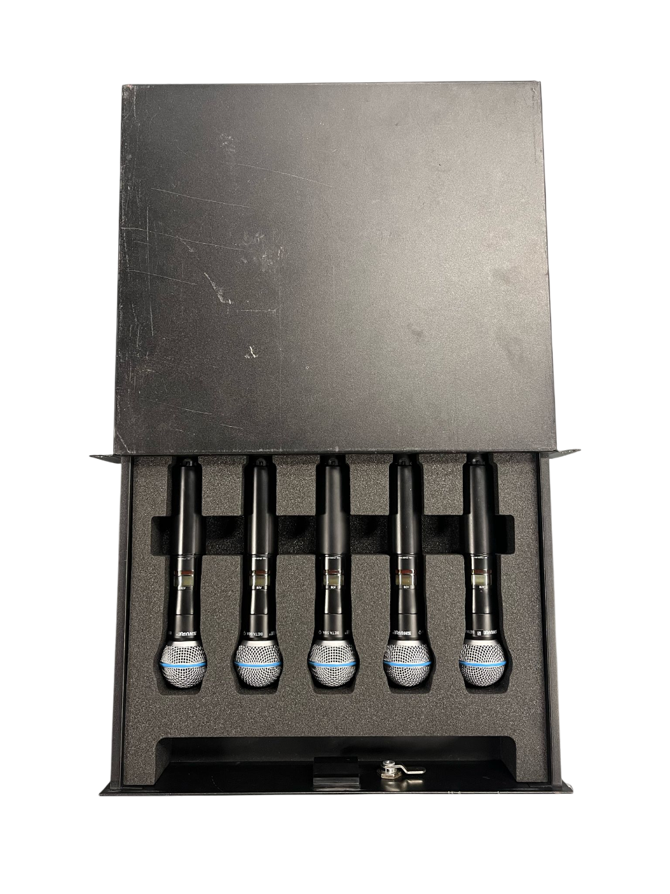 Five microphones arranged in a foam-lined case with a key lock.