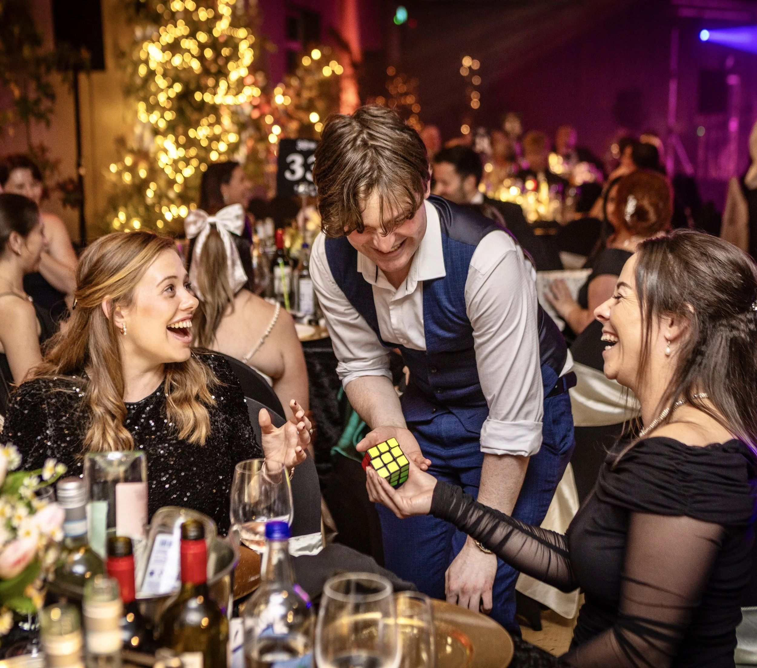 Daniel Maze performing magic at a corporate event with sparkles and glamour!