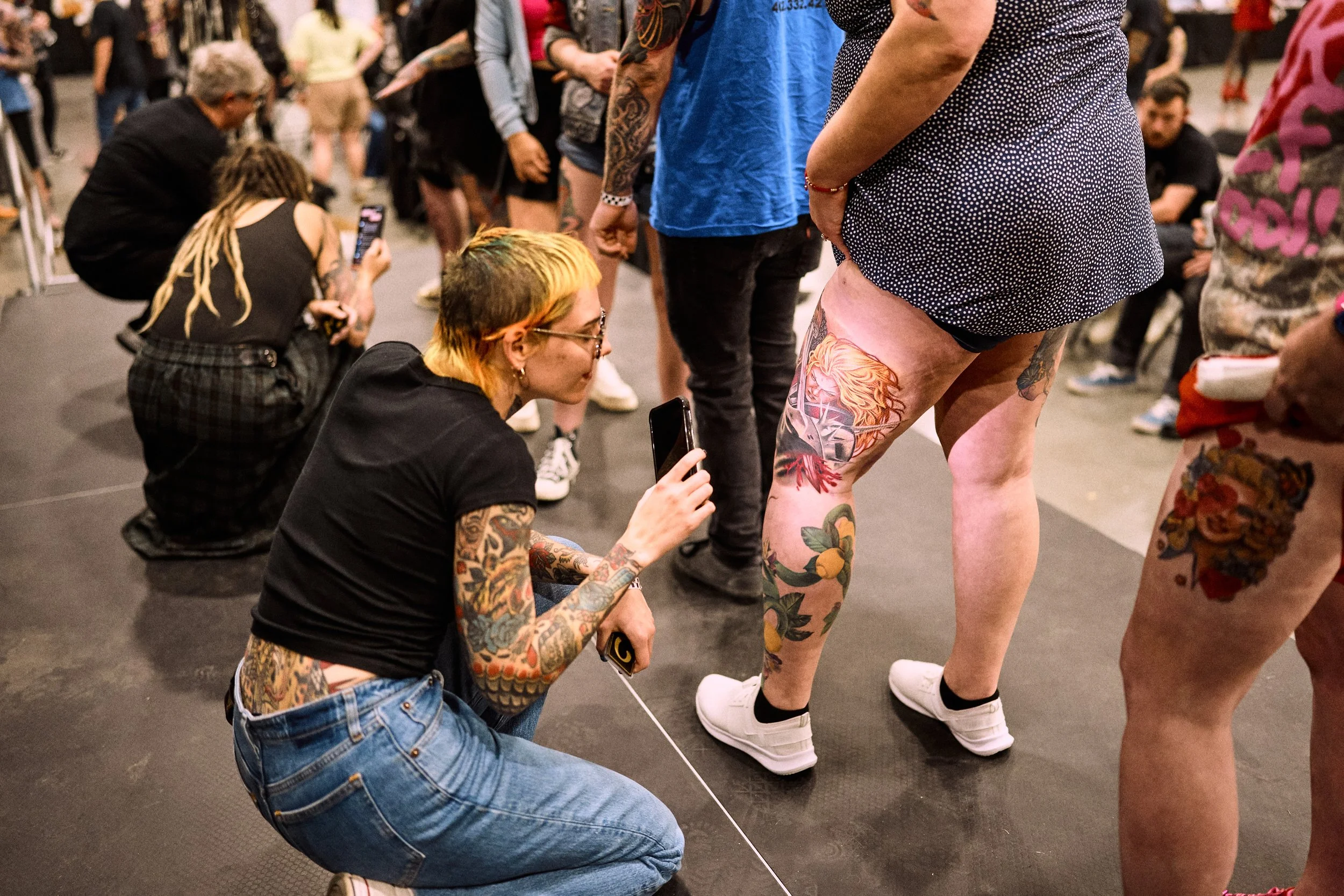 A judge takes a closer look at a tattoo submission for the tattoo contest at Middle Tennessee Tattoo Expo in Nashville, TN