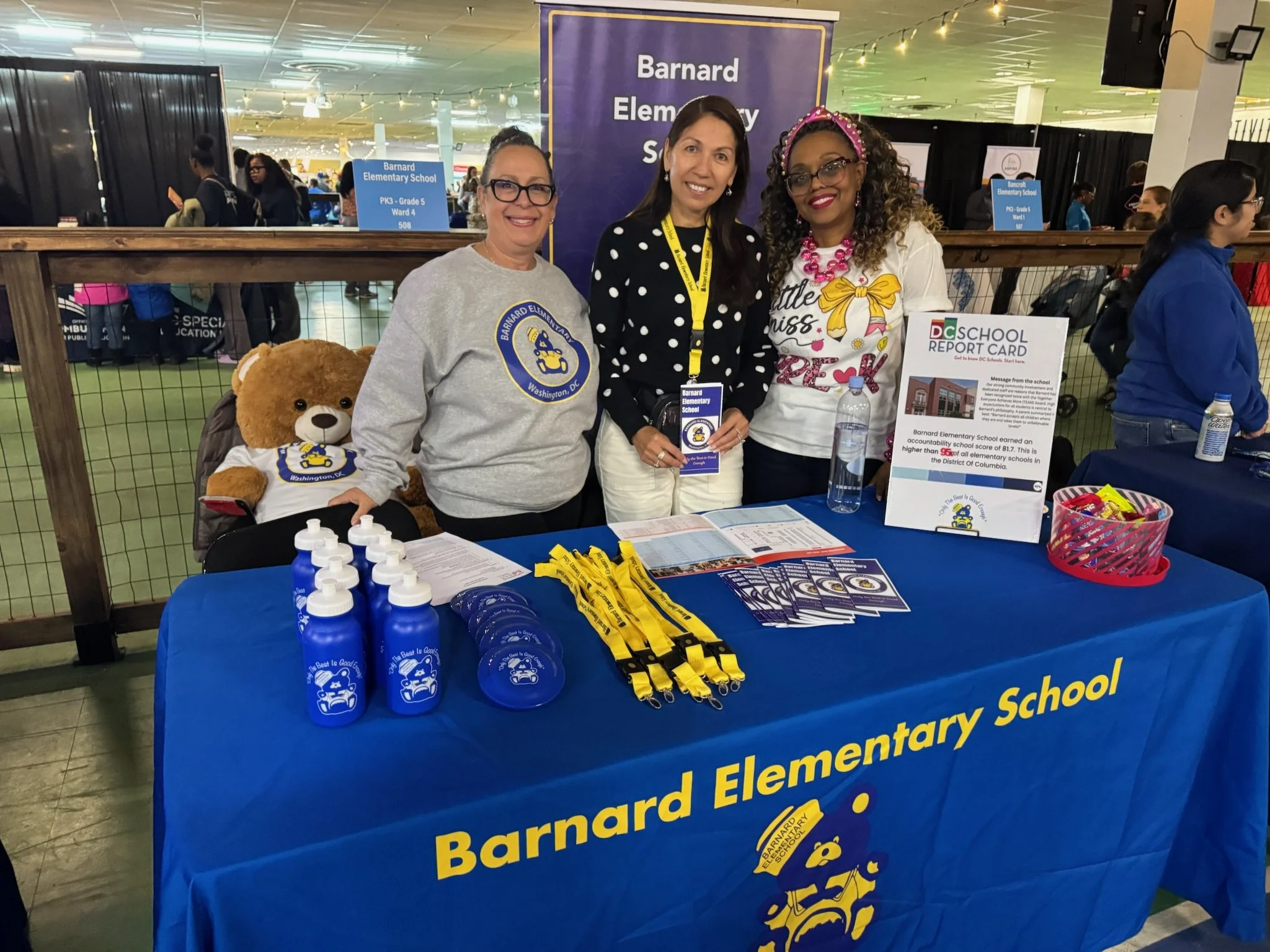 3 teachers representing Barnard at a school fair.