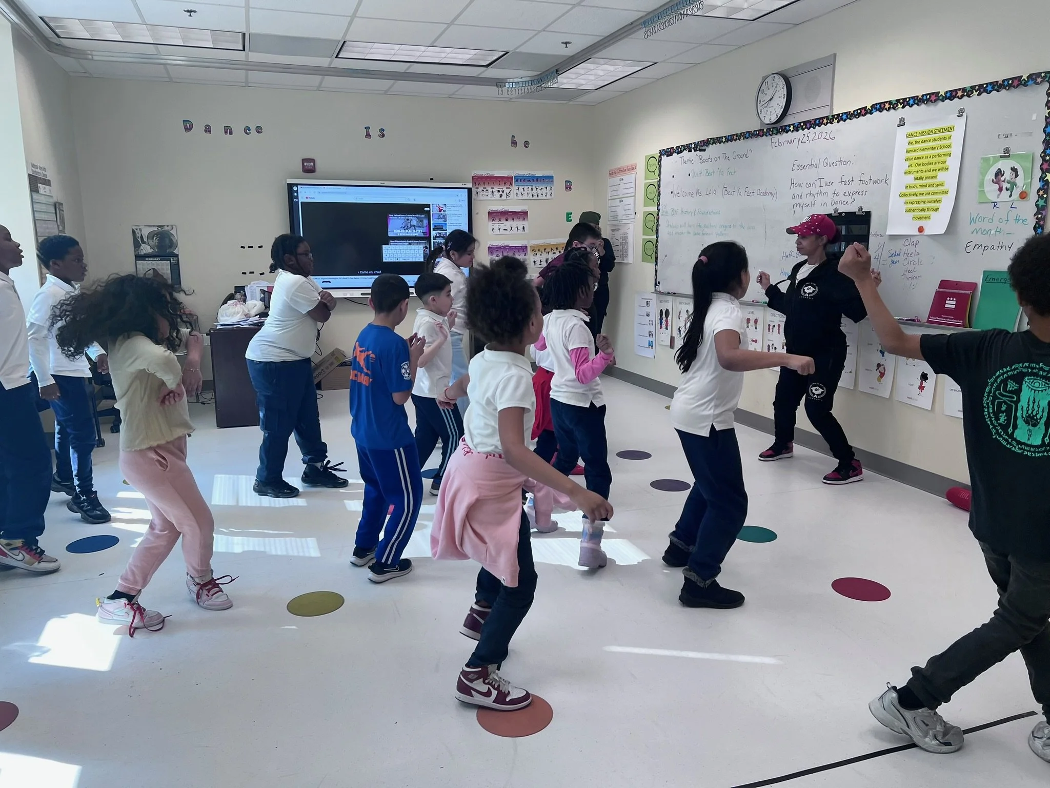 A classroom full of students dancing together.