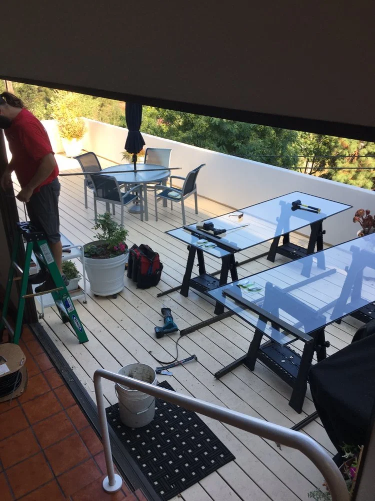 Two sliding glass doors sit on work benches while being repaired at home in Santa Clarita.