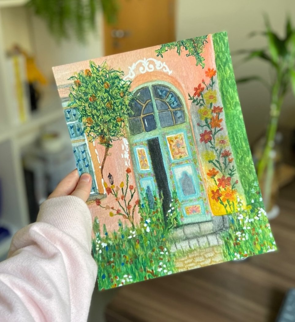 Colorful painting of a house door with a green vine climbing on the left, red and yellow flowers on the right, a small garden with white flowers in front, and a large arched window above the door.