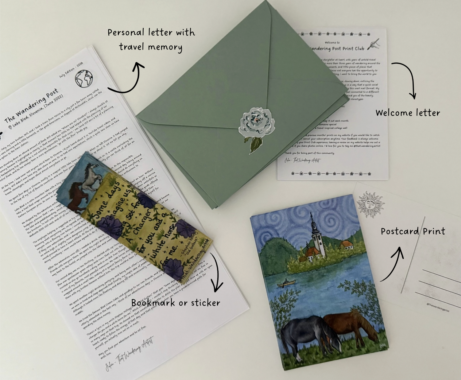 A collection of items on a white surface, including a printed newsletter, a bookmark or sticker, a green envelope with a flower sticker, a welcome letter, a postcard with a lakeside scene, and a small piece of paper with a handwritten personal letter.