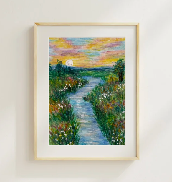 A framed landscape painting of a river winding through lush greenery with colorful wildflowers, under a vibrant sunset sky with a setting sun.