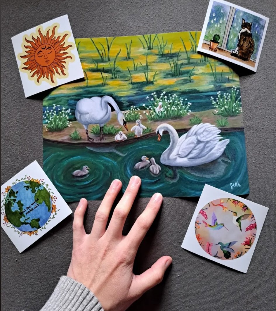Painting of a swan family on a pond with lush greenery and flowers in the background, surrounded by four smaller framed pictures with various nature-themed and whimsical images.