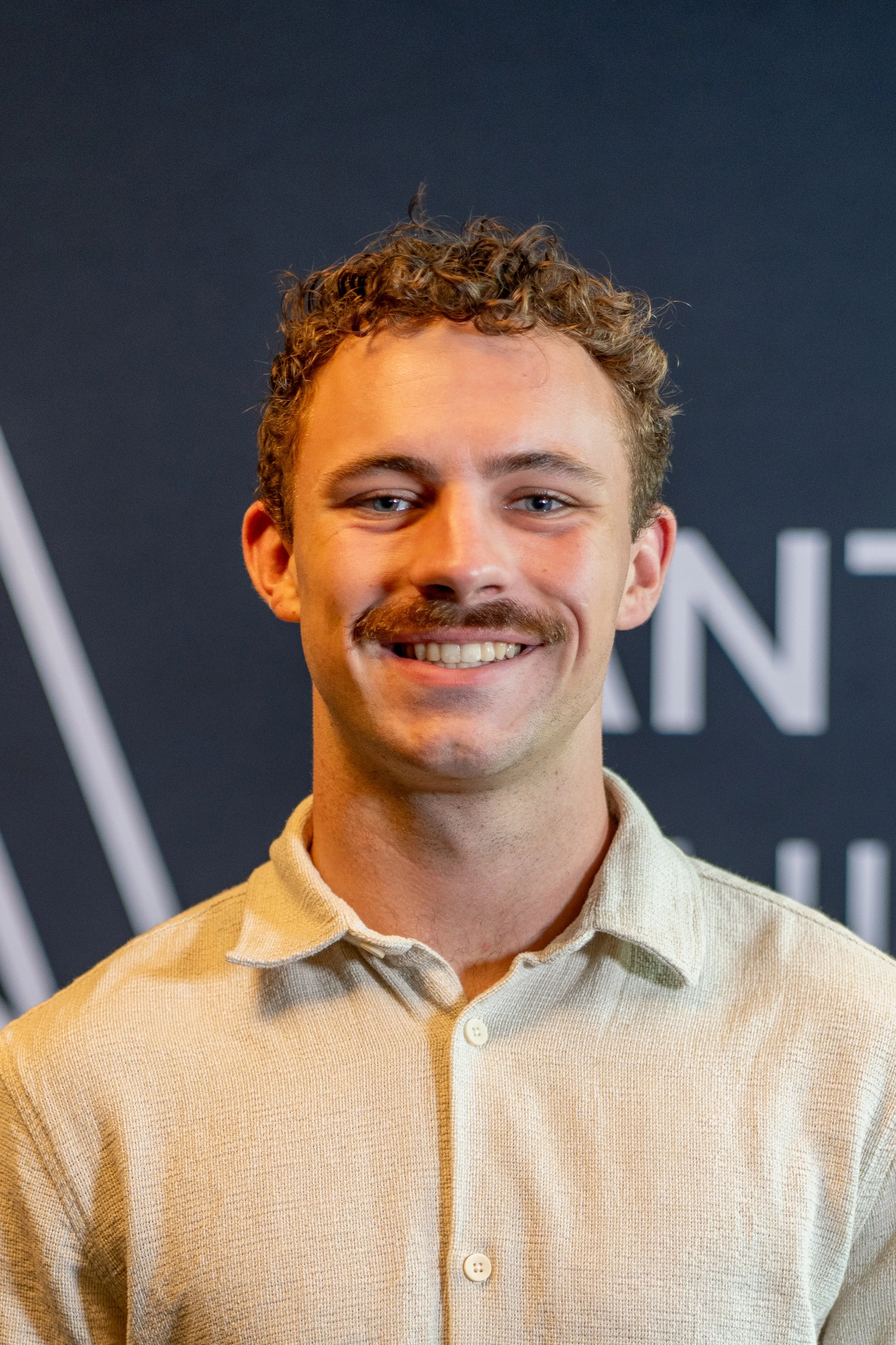 smiling young man with mustache