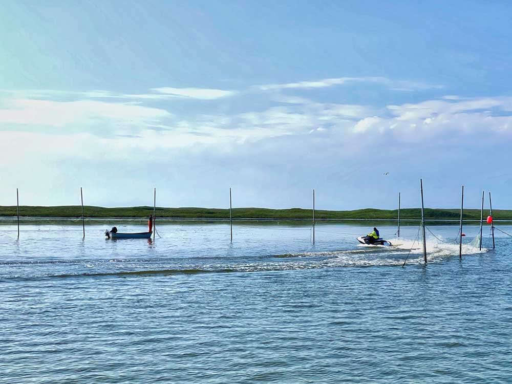 Skiffs check on set nets for salmon.