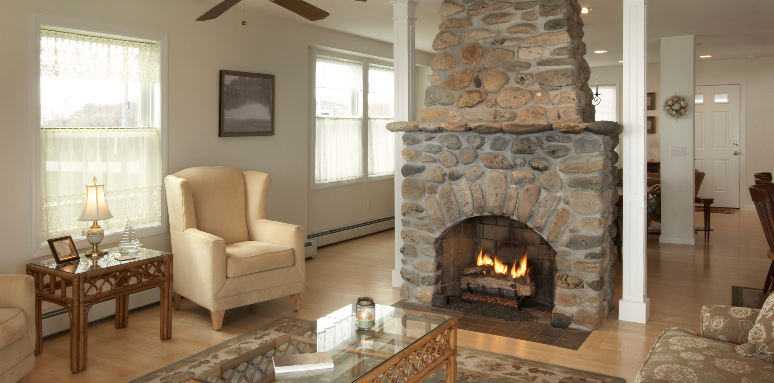 Scenic view of a mountain range with grassy hills in the foreground, under a clear sky.
