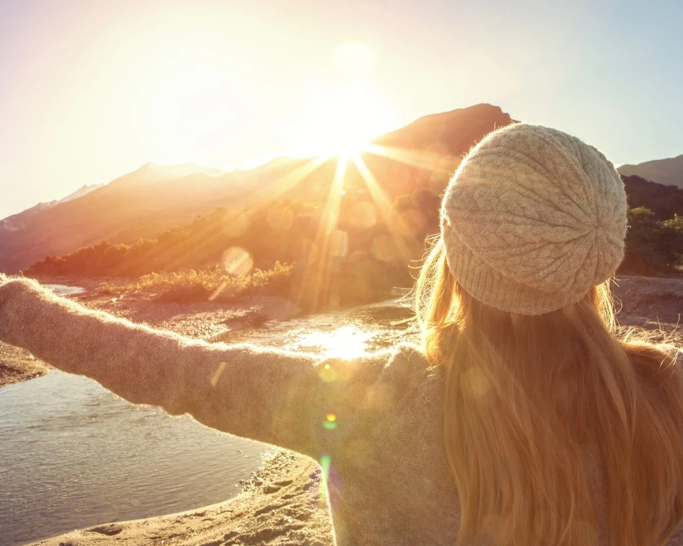 Image of woman looking relaxed and embracing the sun