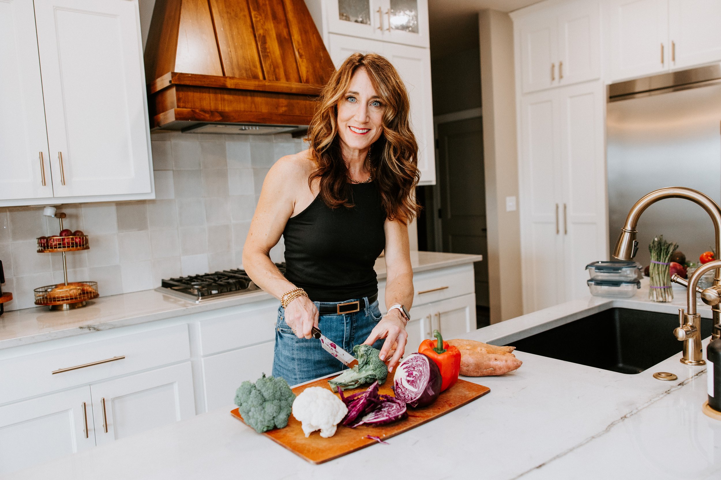 Dana Cushing chopping vegetables in kitchen