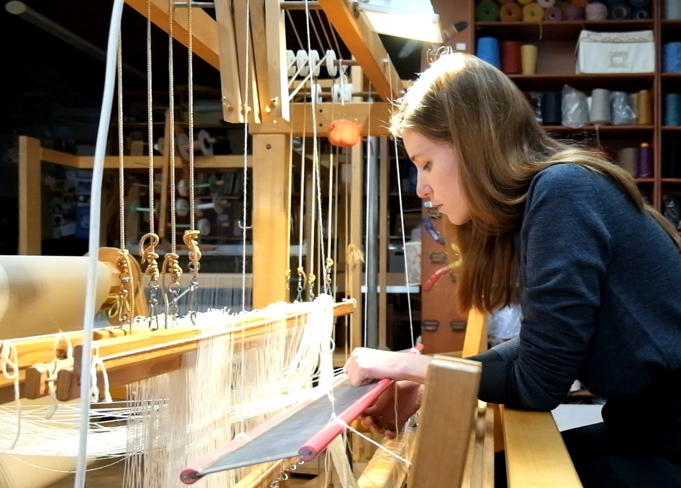 1. Cristina assembling the weaving loom (screenshot video).jpg