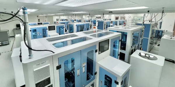 Laboratory filled with multiple blue and white lab or manufacturing equipment.