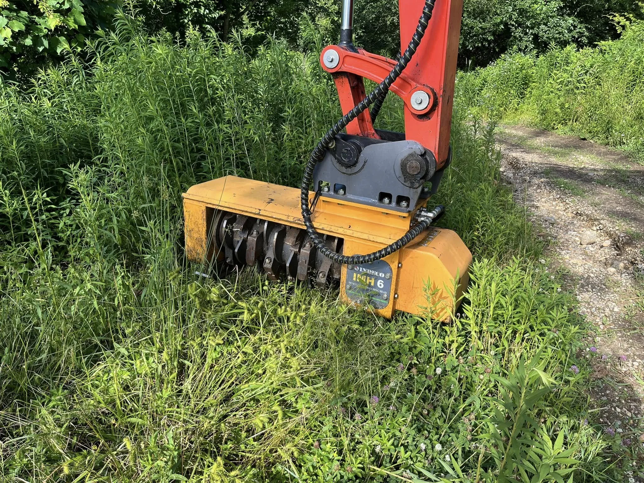 Excavator mounted forestry mulcher in Spencer, Massachusetts. 