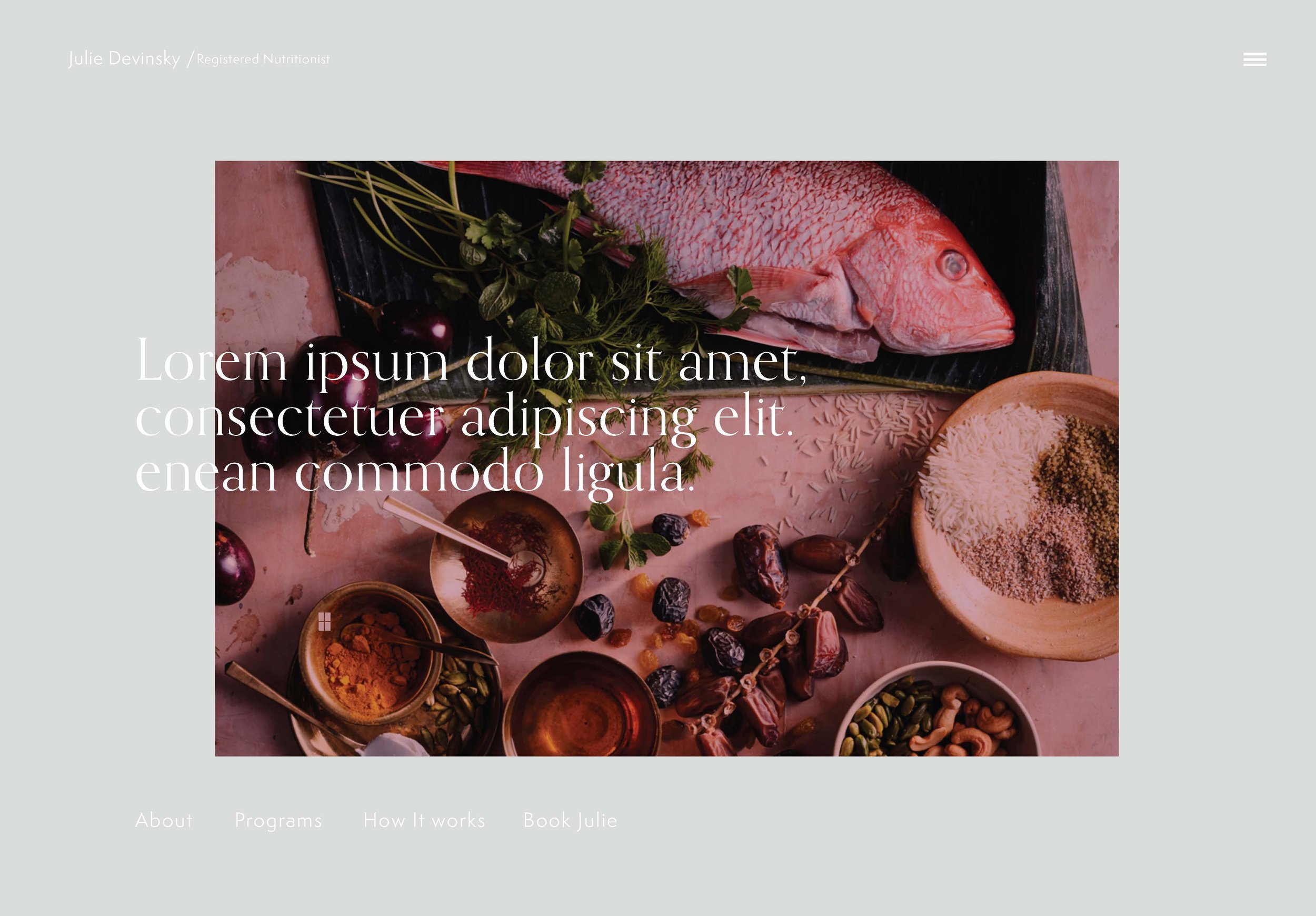 A webpage featuring a raw fish on a black surface with herbs, fruits, spices, and grains surrounding it.