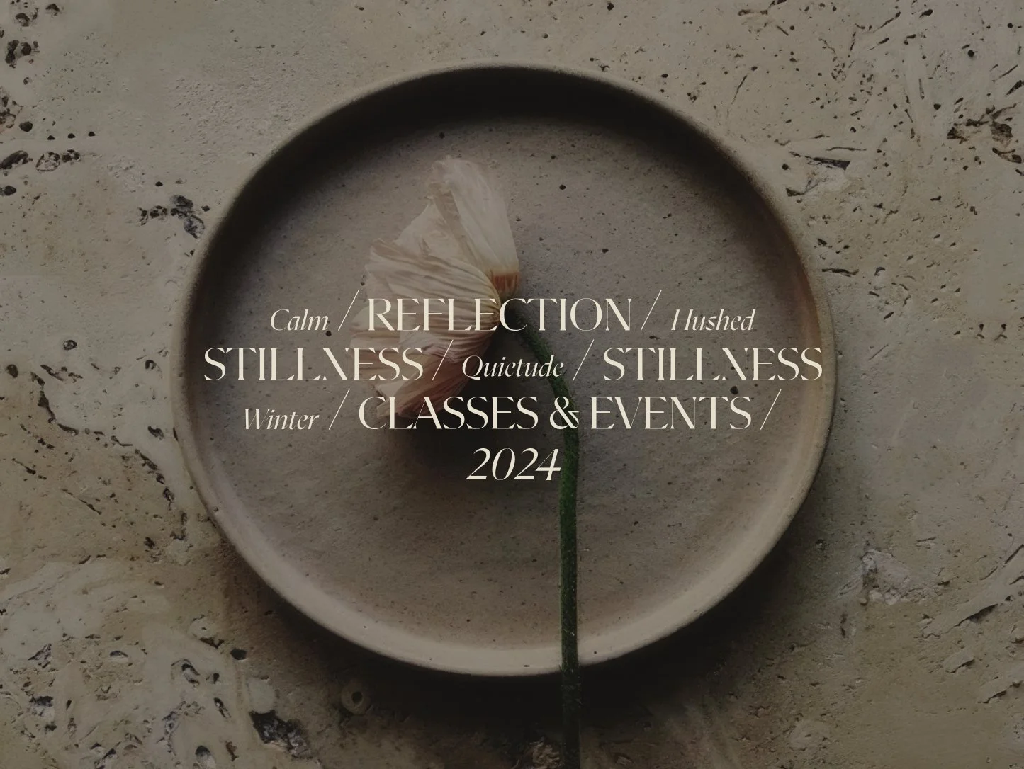 A single cream-colored flower in a round bowl filled with water, placed on a textured surface, with overlaid text about classes and events for winter 2024 focused on calm, reflection, stillness, and quietude.